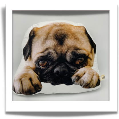 Fawn pug cushion: “Personalised cut-out cushion showing a fawn pug resting its face between its front paws.”Individual Character cushion by 3dogscpt