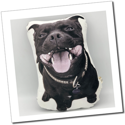 Black Staffordshire bull terrier dog cushion: “Custom cut-out pet cushion featuring a smiling black dog with a collar and name tag.”