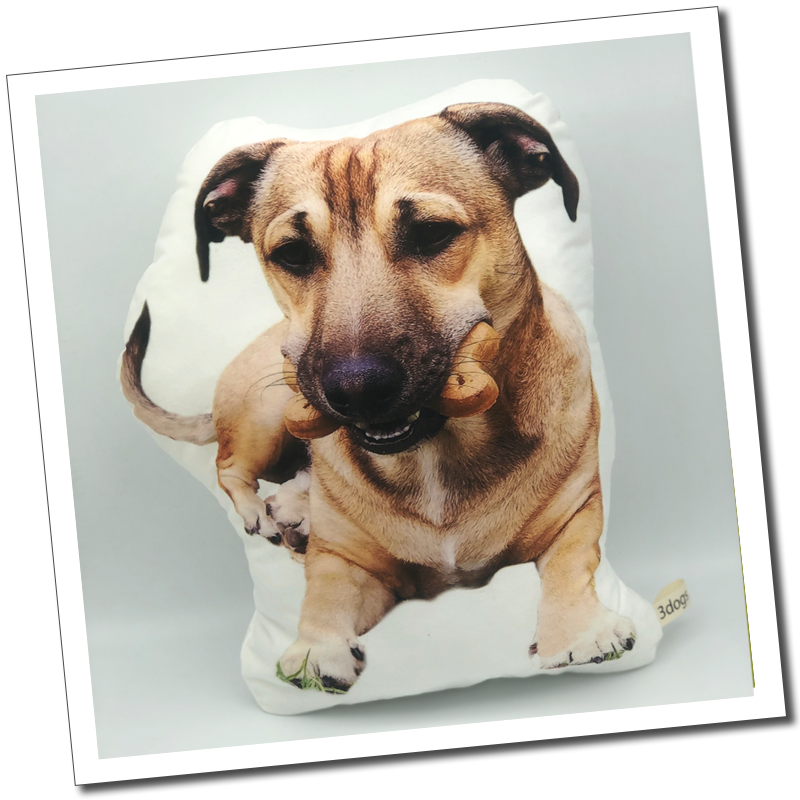Tan dog cushion: “Personalised dog-shaped photo cushion featuring a tan dog holding a chew in its mouth.”